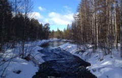 beautiful frozen river in snowy taiga forest