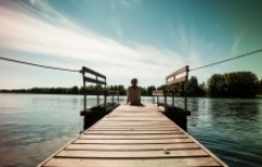 dipping feet in cooling Finnish waters from lakeside accommodation